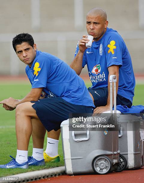 Ronaldo of Brazil has a drink with Cincinho during the Brazil National Football Team training session for the FIFA World Cup Germany 2006 at the...