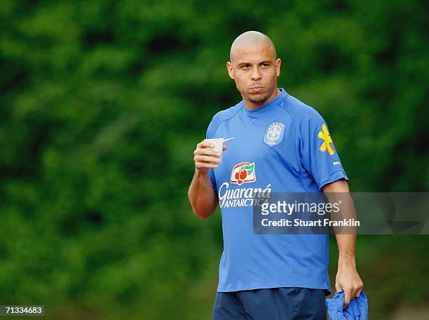 Ronaldo of Brazil has a drink during the Brazil National Football Team training session for the FIFA World Cup Germany 2006 at the Paffrather Street...
