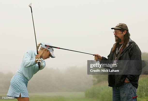 Natalie Gulbis takes some swing advice from her father John Gulbis on the practice range before the first round of the 2006 Women's U.S. Open at...
