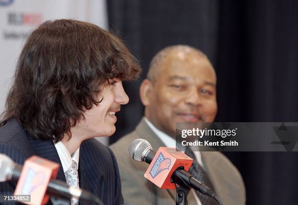 Adam Morrison of the Charlotte Bobcats talks to the press with Head Coach Bernie Bickerstaff on June 29, 2006 at the Charlotte Bobcats Arena in...