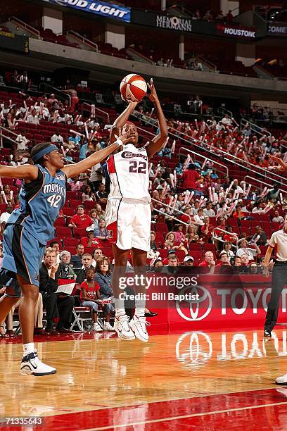 Sheryl Swoops of the Houston Comets shoots over Nikki Teasley of the Washington Mystics June 29, 2006 at the Toyota Center in Houston, Texas. NOTE TO...