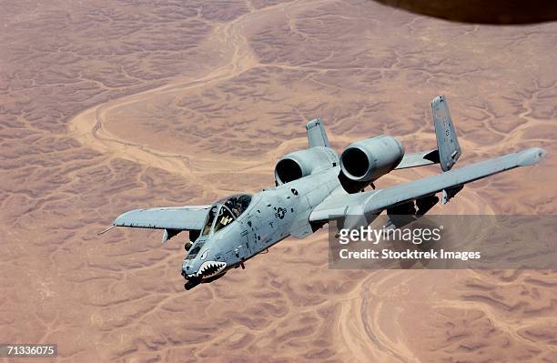 an a-10 thunderbolt from the 407th expeditionary fighter squadron tallil air base, soars above the skies of iraq after receiving fuel from a kc-135, june 19, 2003. - a10 warthog stock pictures, royalty-free photos & images