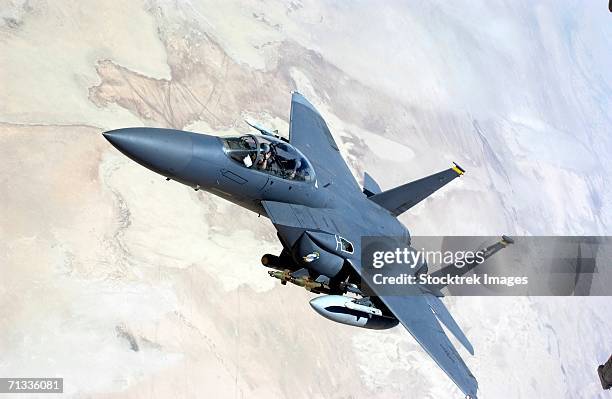 an f-15e strike eagle turns away from the 908 expeditionary air refueling squadron kc-10 after receiving fuel during a mission in support of operation iraqi freedom. - f 15 stock-fotos und bilder