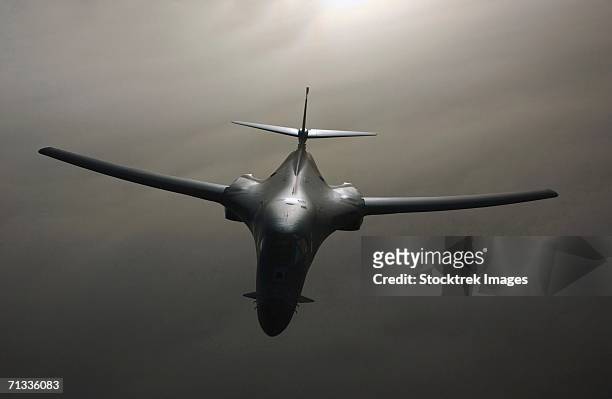 a b-1 bomber proceeds on his mission after receiving fuel from a kc-135 stratotanker in the skies near iraq on march 25, 2003 in support of operation iraqi freedom. - b1 bomber stock pictures, royalty-free photos & images