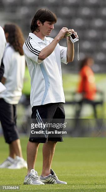 Lionel Messi takes a picture during the Argentina National Football Team training session at the Olympic Stadium Berlin on June 29, 2006 in Berlin,...