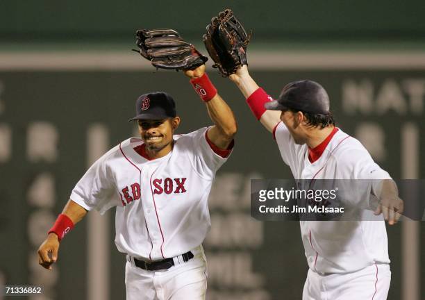 Trot Nixon of the Boston Red Sox celebrates with teammate Coco Crisp after Crisp made a diving catch in center field for the third out against the...