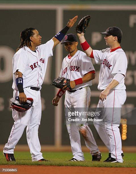Outfielders Manny Ramirez, Coco Crisp, and Trot Nixon of the Boston Red Sox celebrate their 4-2 victory over the New York Mets on June 29, 2006 at...