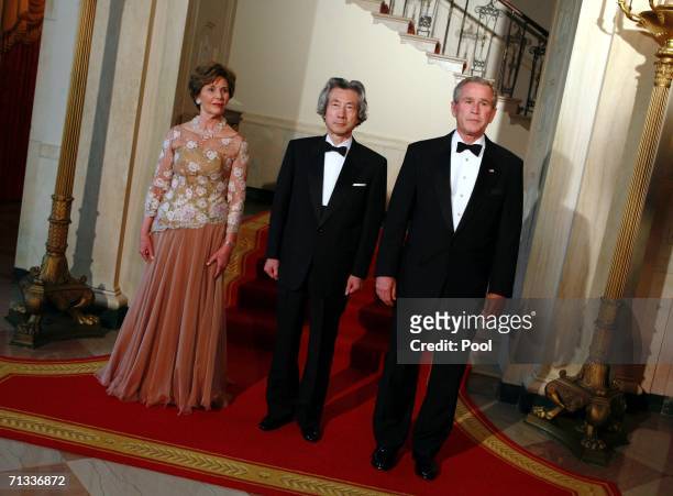 First lady Laura Bush, Japanese Prime Minister Junichiro Koizumi and U.S. President George W. Bush pose in the Grand Foyer for a photo opportunity at...