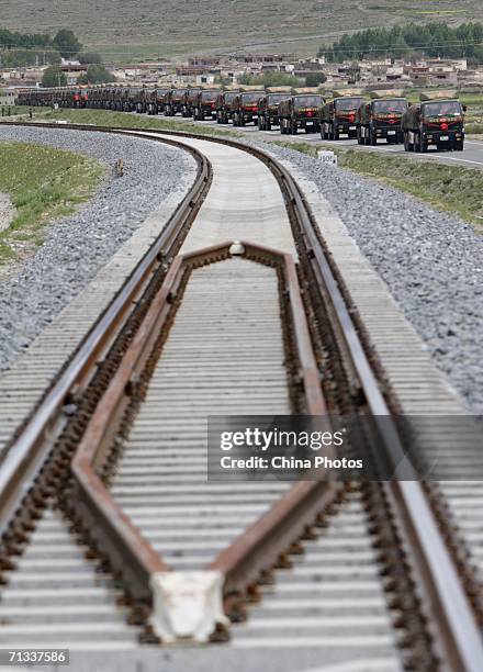 Military trucks run along the Qinghai-Tibet Railway on June 25, 2006 in Duilongdeqing County of Tibet Autonomous Region, China. The Qinghai-Tibet...