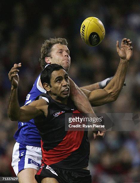 Glenn Archer of the Kangaroos spoils Nathan Lovett-Murray of the Bombers during the round 13 AFL match between the Kangaroos and Essendon Bombers at...