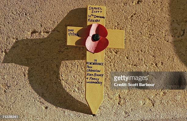 Cross in memory of a soldier killed in the Battle of Somme rests against the memorial at the Thiepval Memorial and Anglo-French Cemetery as the 90th...