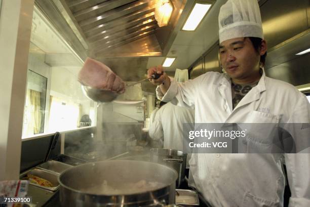 The dinning car onboard a train during a trial run of the 1,956-kilometer-long Qinghai-Tibet railway, linking Xining, capital of Qinghai Province,...