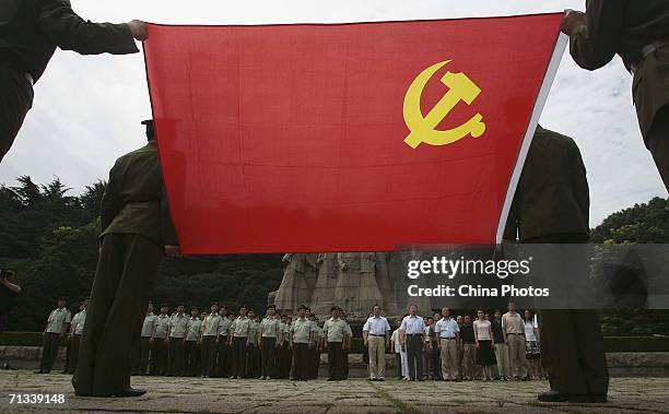 Communists attend a ceremony to admit new members to the Communist Party of China at the Yuhuatai Martyrs' Cemetery on June 30, 2006 in Nanjing of...