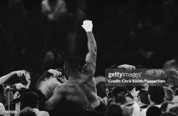 Heavyweight boxer Mike Tyson and trainer Don King celebrating his WBC title victory over Trevor Berbick, 22nd November 1986.