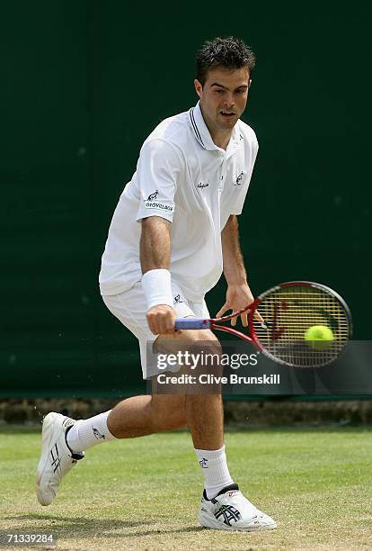 Daniele Bracciali of Italy returns a backhand to Jonas Bjorkman of Sweden during day five of the Wimbledon Lawn Tennis Championships at the All...