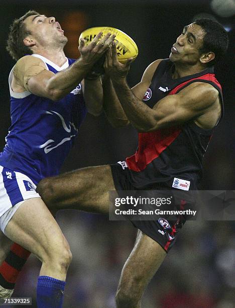 Shannon Watt for the Kangaroos and Nathan Lovett Murray for Essendon in action during the round 13 AFL match between the Kangaroos and Essendon...