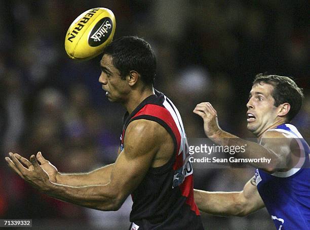 Nathan Lovett Murray for Essendon and Troy Makepeace for the Kangaroos in action during the round 13 AFL match between the Kangaroos and Essendon...