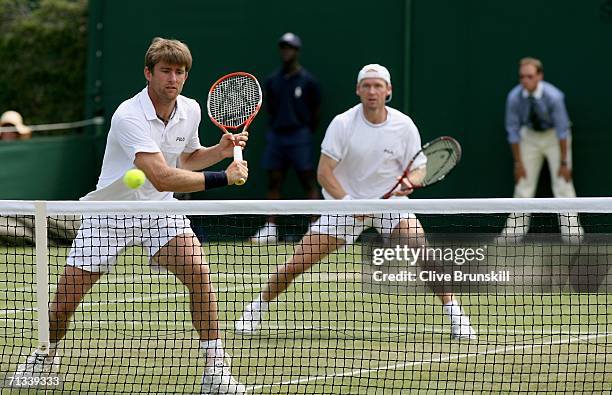 Michael Kohlmann and Rainer Schuettler of Germany in action in their match against Kevin Ullyett of Zimbabwe and Paul Hanley of Australia during day...