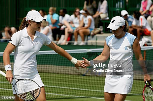 Samantha Stosur of Australia and Lisa Raymond of The United States walk back to the baseline in their match against Abigail Spears and Amy Frazier of...