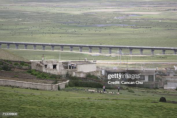 The trainline of the newly built Qinghai-Tibet Railway runs past a village in Dangxiong County, Tibetan Autonomous Region, China on June 30, 2006....