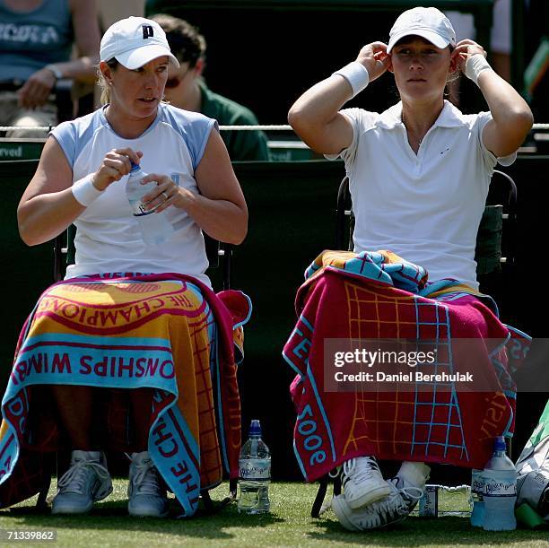 Samantha Stosur of Australia and Lisa Raymond of The United States take a break between games in their match against Abigail Spears and Amy Frazier...