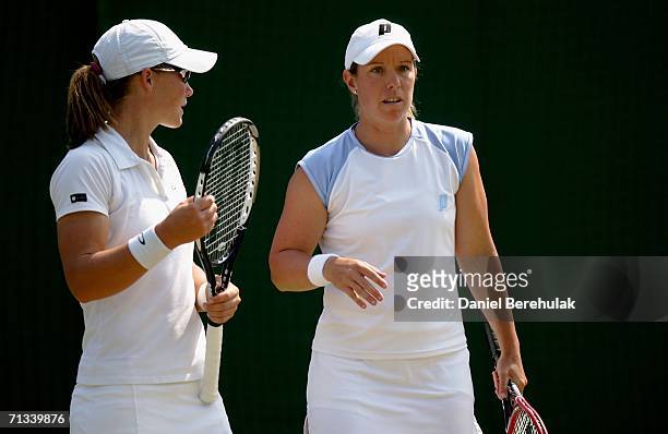 Samantha Stosur of Australia and Lisa Raymond of The United States talk tactics in their match against Abigail Spears and Amy Frazier of The United...