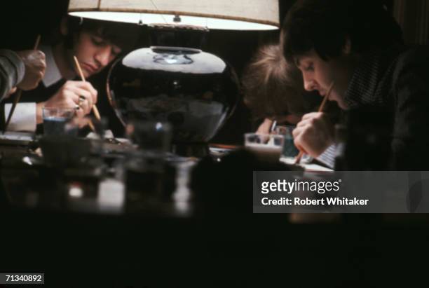 Beatles George Harrison , Ringo Starr, John Lennon and Paul McCartney, busy completing their only known collaborative artwork, 'Images of a Woman' at...