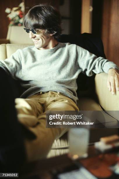 George Harrison relaxing at the Beatles? hotel suite at the Tokyo Hilton Hotel, Japan, during their tour of Asia, 1966.