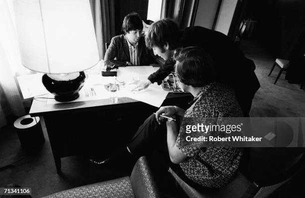Paul McCartney, John Lennon and Beatles' road manager Mal Evans painting in the Beatles Tokyo Hilton suite, during the band's tour of Asia, 1966.