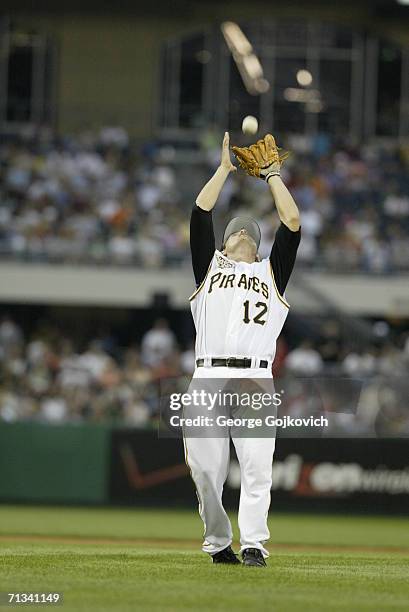 Third baseman Freddy Sanchez of the Pittsburgh Pirates catches a fly ball during a game against the Chicago White Sox at PNC Park on June 28, 2006 in...