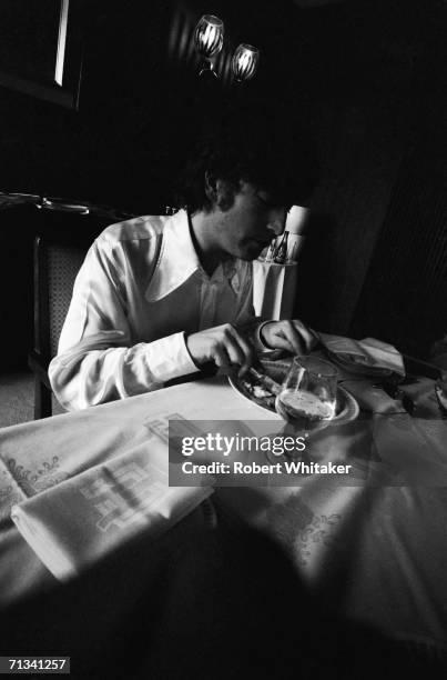 John Lennon eating breakfast in the Beatles' hotel suite at the Tokyo Hilton, 1966.