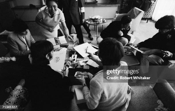 Beatles Ringo Starr, glasses, John Lennon, George Harrison, Beatles? manager Brian Epstein, a Tokyo guest and Paul McCartney, backstage at the...