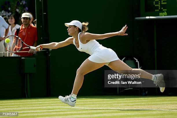 Severine Bremond of France stretches for a forehand to Gisela Dulko of Argentina during day five of the Wimbledon Lawn Tennis Championships at the...