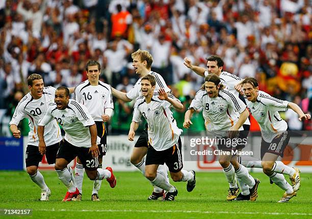 Germany celebrate following their team's victory in a penalty shootout at the end of the FIFA World Cup Germany 2006 Quarter-final match between...
