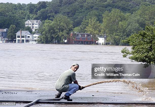 Stinson of Lambertville, New Jersey pumps water from the parking lot of The Lambertville Station Inn along the Delaware River as flood water starts...