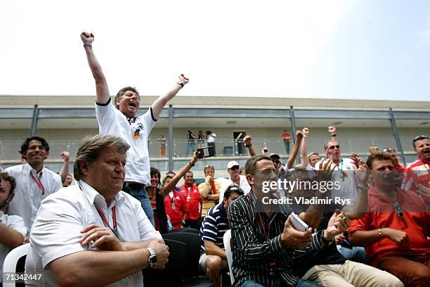 Mercedes Motorsport director Norbert Haug and other fans watch the Germany v Argentina world cup match in the paddock during practice for F1 United...