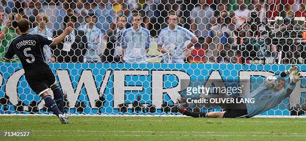 German goalkeeper Jens Lehmann dives to save a penalty kick by Argentinian midfielder Esteban Cambiasso to win the game during a penalty shootout at...