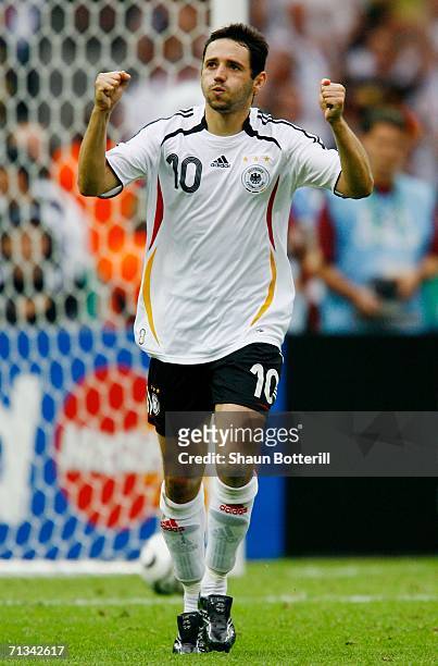 Oliver Neuville of Germany celebrates scoring a penalty in a penalty shootout during the FIFA World Cup Germany 2006 Quarter-final match between...