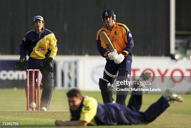 Heath Streak of Warwickshire looks on as he plays the ball past Martyn Ball of Gloucestershire looks on during the Twenty20 match between...