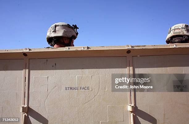 Army troops wait in an armored humvee for helicopter transport to take them from their base at Deh Afghan on June 30, 2006 in the Zabul province of...