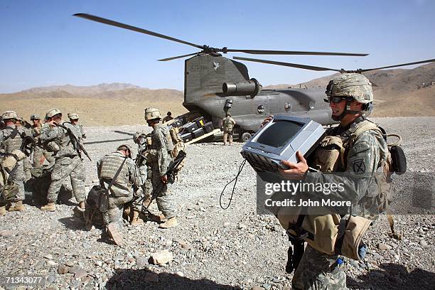 Army troops await helicopter transport to take them from their base at Deh Afghan on June 30, 2006 in the Zabul province of southern Afghanistan....