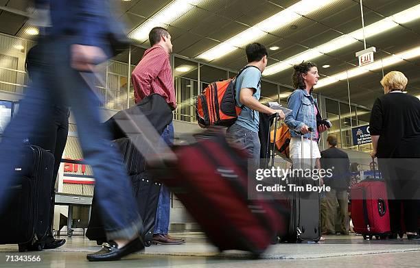 Travelers wait in line in Terminal 3 June 30, 2006 at O'Hare International Airport in Chicago, Illinois. Heavy holiday travel is expected as the U.S....