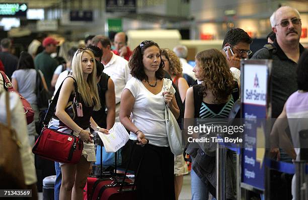 Travelers wait in line in Terminal 3 June 30, 2006 at O'Hare International Airport in Chicago, Illinois. Heavy holiday travel is expected as the U.S....
