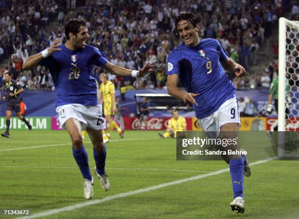 Luca Toni of Italy, is congratulated by teammate Simone Perrotta, after scoring his team's third goal during the FIFA World Cup Germany 2006...