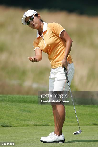 Ai Miyazato of Japan reacts to missing a putt during the first round of the 2006 Women's U.S. Open at Newport Country Club on June 30, 2006 in...