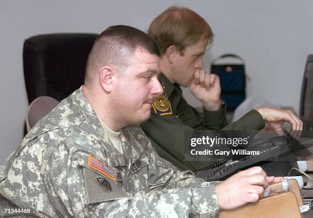 Army Specialist Shenandoah Rogers, of the Arizona National Guard?s 180th Field Artillery unit, works his computer's joy stick that controls a remote...