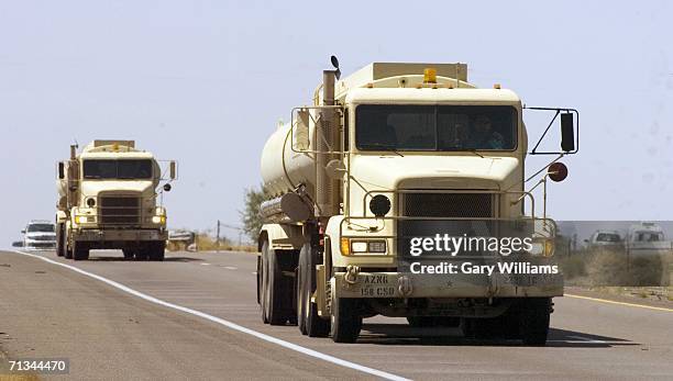 Two of six fuel trucks from the Arizona National Guard drive up International road 19 June 30, 2006 from the border town of Nogales, Arizona. The...