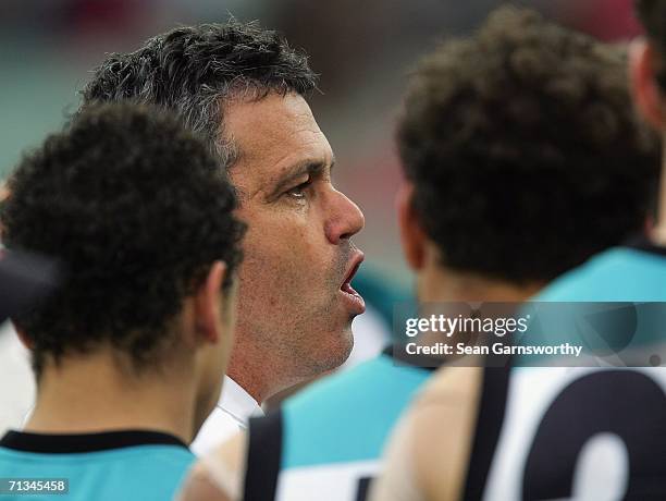 Port Adelaide Coach Mark Williams addresses his players during the round thirteen AFL match between Melbourne and Port Adelaide at the Melbourne...