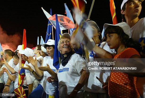 Supporters of the Macedonian ruling party SDSM wave party and state flags at the election rally in Skopje, 30 June 2006. Macedonian political parties...