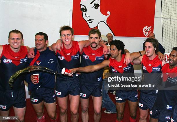 The Melbourne team celebrates winning the round thirteen AFL match between Melbourne and Port Adelaide at the Melbourne Cricket Ground on July 1,...